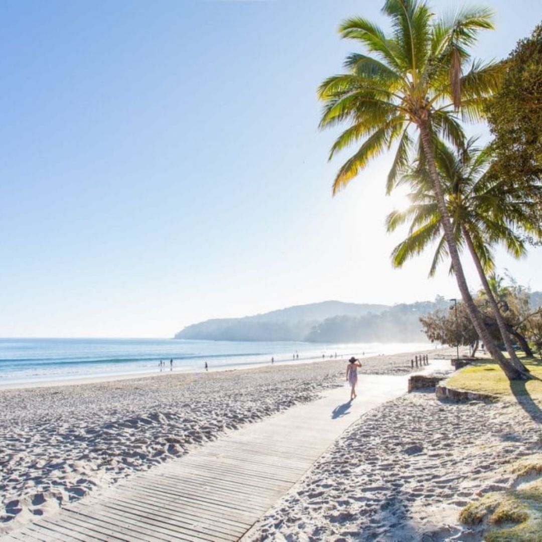 Stroll along the boardwalk on Noosa main beach in Hastings street